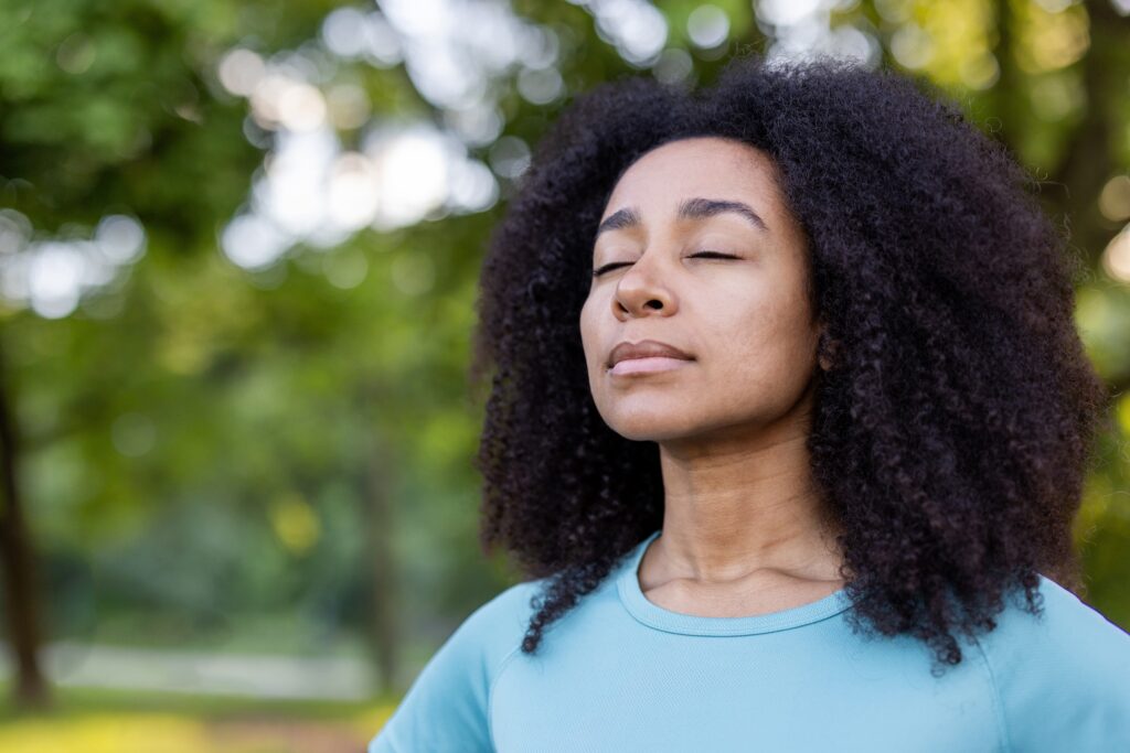 Woman,Embracing,Mindfulness,In,Tranquil,Outdoor,Environment,,Eyes,Closed,In