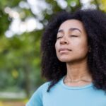 Woman,Embracing,Mindfulness,In,Tranquil,Outdoor,Environment,,Eyes,Closed,In